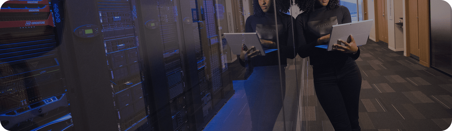 A person working on a laptop in a modern data centre
